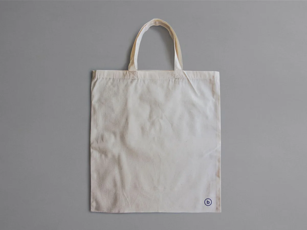 Plain cotton tote bag on a neutral background