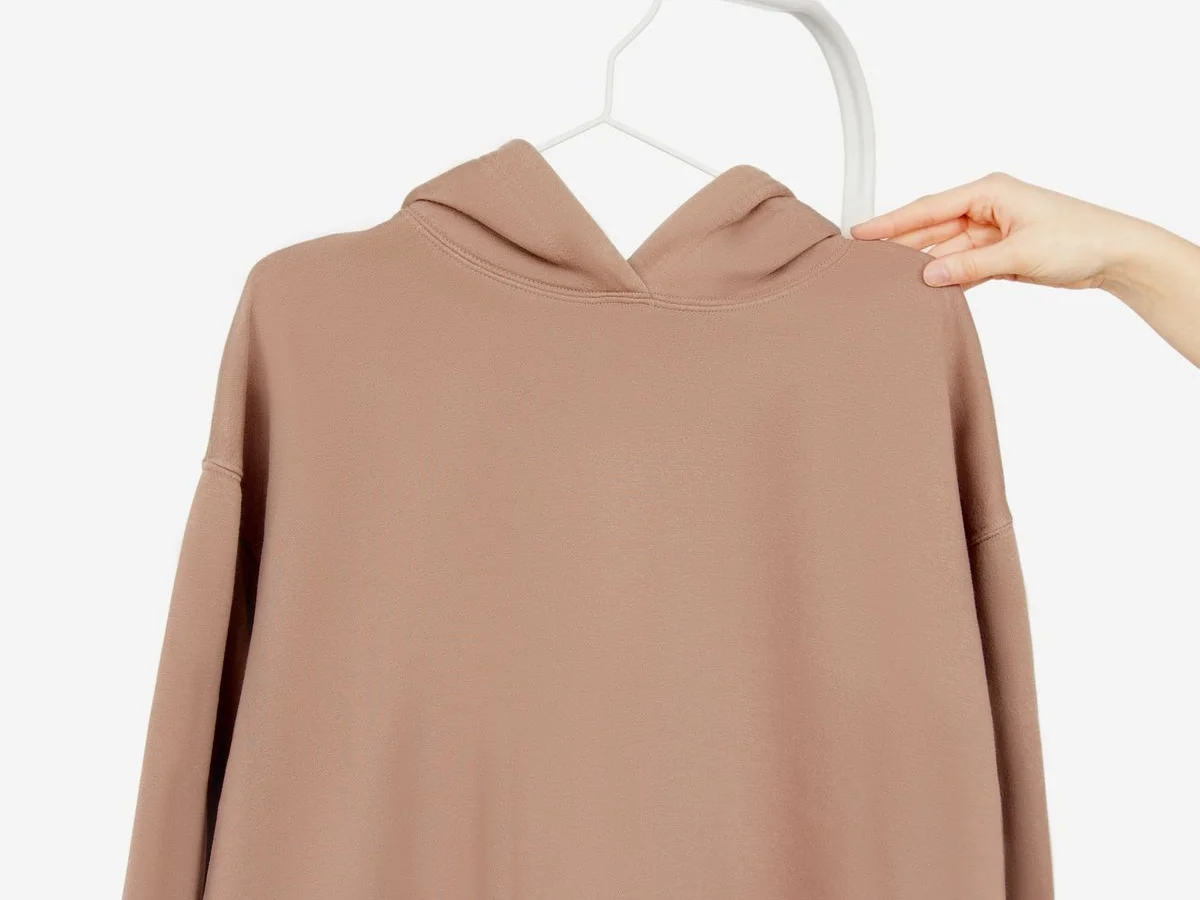Plain brown hooded sweatshirt on a hanger